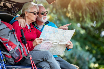 Hiking-senior hikers looking at map