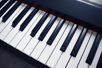 Fototapeta na wymiar Digital Piano Keyboard - Photo of a musical instrument, closeup with white and black keys