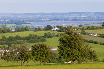 Fototapeta na wymiar A view of the Severn Vale and The Noose in the River Severn, taken from Littledean Hill on the edge of the Forest of Dean, Gloucestershire UK - Littledean is in the foreground