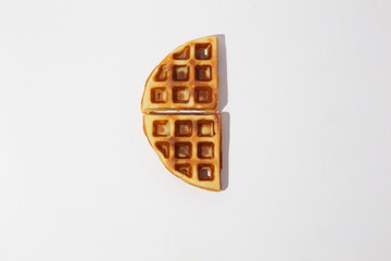 Delicious breakfast with waffles. Belgium waffle topped with boysenberry syrup, whipped cream, walnuts, banana, egg, chicken and freshly chopped strawberries horizontal shot, top view with front view