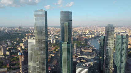 An aerial view of shiny skyscrapers in the middle of urbanscape