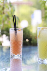 lemonade in glass glasses is on the table on a sunny day