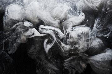 Abstract dark paint in water background. White smoke cloud motion on black, acrylic ink swirl...