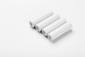 AA size alkaline batteries on a white background. Several batteries in a row.