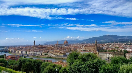 Fototapeta na wymiar Panorama of the historic part of Florence. Churches, houses, river, sky and hills. Tuscany. Italy. Europe