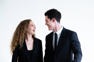 Portrait of young man and woman wearing suit talking and smilling isolated on white. Coworkers. Business people collaboration teamwork concept. People business people talking for business project.