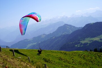 Rigi Kulm, Switzerland 08 14 2021 Launching a paraglide downhill. Tandem flight among Alp mountains in central Switzerland. 