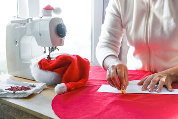 Obraz premium Christmas,Handmade Sewing.Recycling Handmade DIY hand home.sewing machine project lockdown. home sewing,Hobby, meditation,zero waste,recycling. Girl sews clothes home sewing machine,ecology zero waste