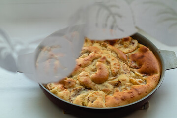 Apple pie with cinnamon peeks out for white tulle.