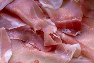 Thin slices of jamon close up food background
