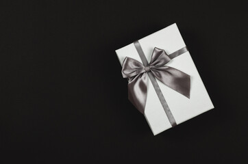 White gift box on a black background. Festive concept