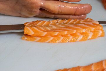 preparation of sushi and salmon oniguiri with cream tease