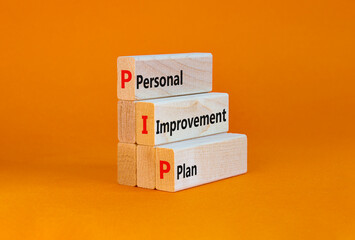PIP, Personal improvement plan symbol. Words PIP, Personal improvement plan symbol on blocks on a beautiful orange background. Business, PIP, Personal improvement plan symbol concept. Copy space.