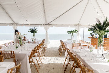 Beautiful white banquet hall under a tent for a wedding reception Interior of a wedding tent...