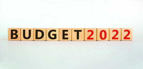 Business concept of budget planning 2022. Words 'Budget 2022' on wooden cubes. Beautiful white table, white background. Business and budget 2021 new year concept. Copy space.