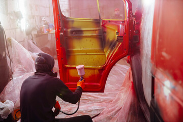 Painting a truck in a spray booth, a man molar car