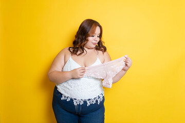 beautiful young plus size woman showing panties, body positive concept