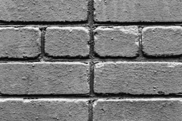 Texture of a brick wall with cracks and scratches which can be used as a background
