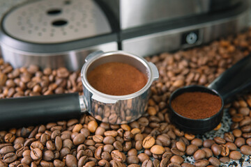 Coffee horn, filter holder and coffee mashine against a background of beans