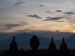 Buddha and stupa silhouettes in the dawn light, Borobudur temple