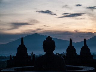 Buddha and stupa silhouettes in the dawn light, Borobudur temple
