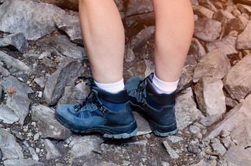 Tourist legs. The mountains. Trekking shoes. Sports sneakers