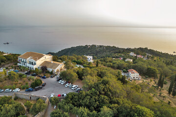 Fototapeta na wymiar Sunset over coast of Corfu with Pelekas village, Greece.
