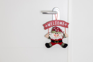 Decoration santa claus welcoming in an entrance to a house