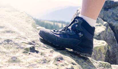 Tourist legs. The mountains. Trekking shoes. Sports sneakers