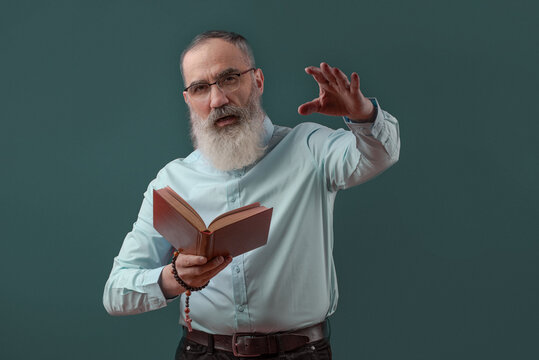 Senior charismatic man holding a book