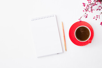 Obraz na płótnie Canvas Mockup open white notepad with cup of coffee and branches with red berries on a white background