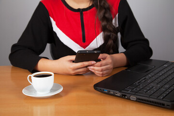  Girl typing on mobile phone having fun online or chatting with friends. He drinking coffee.