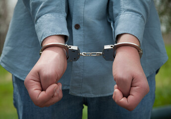 Businessman in handcuffs, criminal concept.