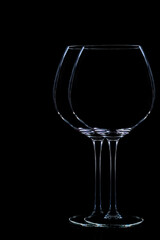 Style life of two wine glasses on black background.