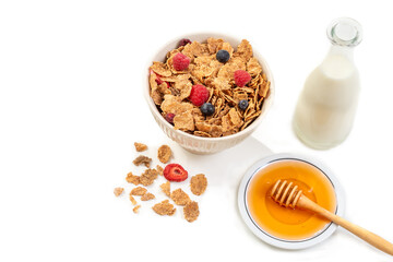 Healthy breakfast with bowl of cereal, milk and honey.