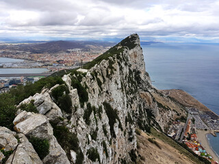 Aerial view of top of Gibraltar Rock, in Upper Rock Natural Reserve with Gibraltar town, Mediterranean Sea, cloudy day