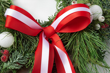 Christmas red decorative bow with white ribbon on new year tree.Christmas decoration with ribbon