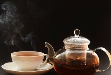tea in a glass mug and a teapot