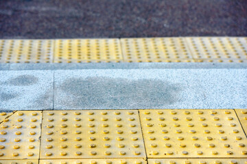 Yellow Braille block for blind handicap on the floor before stairs. Tactile tiles in front of the...