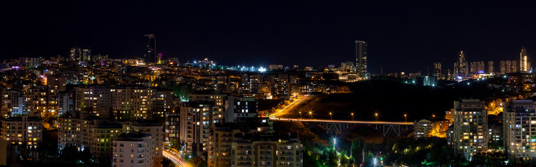 Fototapeta na wymiar Beautiful panoramic cityscape of Cankaya, Oran and Dikmen districts in Ankara at night. Long exposure photography of Dikmen Valley Bridge and surrounding buildings.