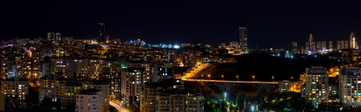 Beautiful panoramic cityscape of Cankaya, Oran and Dikmen districts in Ankara at night. Long exposure photography of Dikmen Valley Bridge and surrounding buildings.