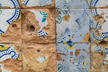 Detail of wall ornamented with classic Portuguese tiles in ruins, affected by the action of time