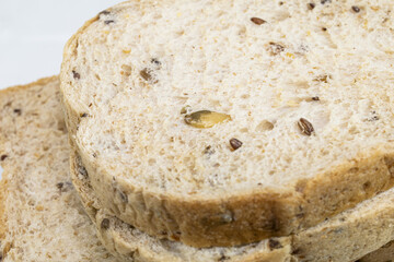Whole wheat bread slice on white background.