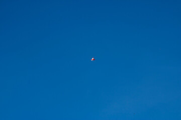 White and Red Balloons Floating in the Middle of a Clear Blue Sky