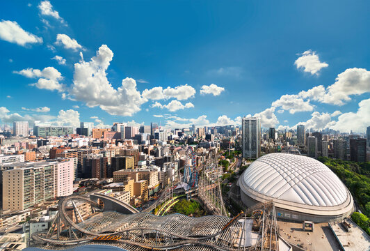 tokyo, japan - may 03 2021: Bird view of the steel roller coaster Thunder Dolphin above the shopping center Laqua Tokyo Dome City Mall in kourakuen aside the Tokyo Dome stadium called The Big Egg.