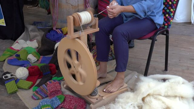 old style wool deburring , yarn making machine, spindle for making yarn, colorful wool knitted socks