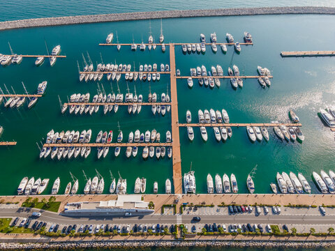 Aerial view of Marina d'Arechi port, a big pontoon with sailing yacht along the shoreline, Salerno, Italy.
