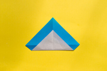 Step by step photo instruction how to make origami paper penguin. Simple diy kids children's concept.