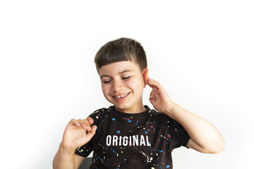 caucasian boy making gesture of not hearing on white background