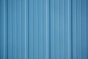 Light blue metal panel. Light blue wall with vertical stripes.
